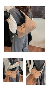 Macro detail of khaki pleated hobo bag showing fine vertical textures and silver buckle