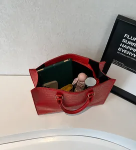 Spacious red crocodile embossed tote bag showing interior storage for iPad and essentials