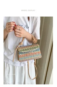 Detail of colorful woven handbag featuring geometric patterns and matching strap