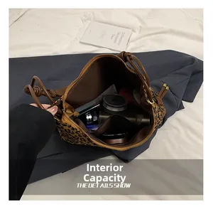 Detailed interior view of leopard print tote bag showing large capacity and inner pockets
