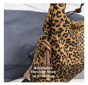 Detail showing the adjustable leopard print tote bag with brown leather drawstring straps