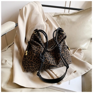 Detailed close-up of leopard print canvas tote bag with black knotted rope handles