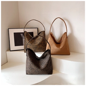 Detailed comparison of three large hobo tote bags in leopard print and solid brown suede