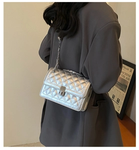 Chic silver quilted chain bag shown on a model with a dark grey oversized blazer