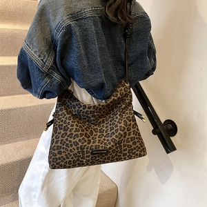 Chic leopard print hobo tote bag for women featuring drawstring closure and long shoulder strap