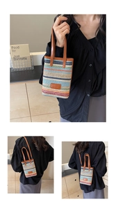 Detail showing colorful rainbow woven straw texture with brown leather strap and logo patch
