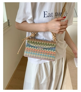 Detail of colorful woven ethnic crossbody bag with geometric patterns and knotted strap