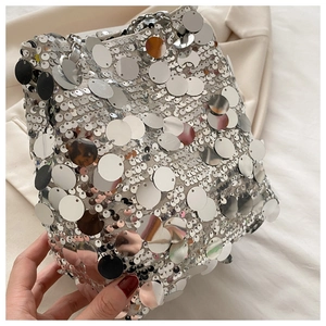 Detailed view of large silver sequins and metallic chain on this stylish bucket bag