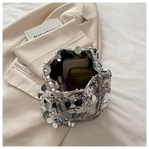 Close-up of silver sequin bucket bag showing interior space for phone and makeup