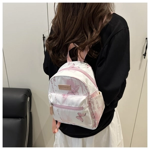Close-up of butterfly print and Chinese calligraphy on this white mini backpack