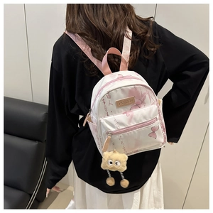 Mini floral white backpack shown worn by model to display stylish compact size and fit