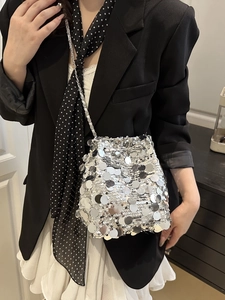 Sparkly silver sequin bucket bag with metal chain strap for stylish summer fashion look