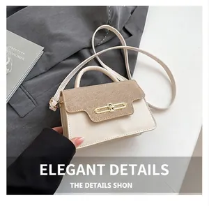 Detail view of contrast stitching handbag with gold clasp lock and premium textured finish