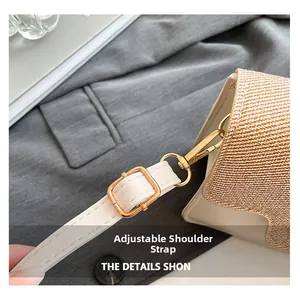 Detail of adjustable leather strap and golden metal hook on contrast stitching handbag
