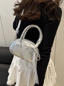 Silver metallic mini handbag with heart patch and white lace bow detail for women