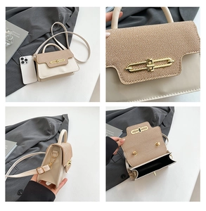 Detail of mini cream crossbody bag with straw flap, gold clasp, and internal compartment