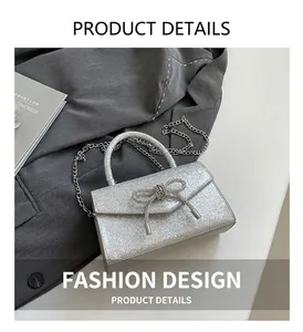 Detail of silver glitter mini bag with rhinestone bow and metallic handle for evening