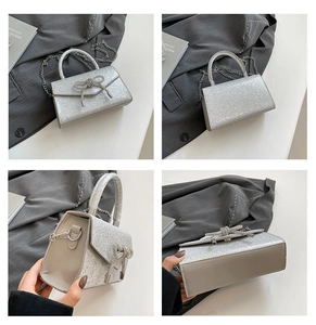 Detail view of silver sequin handbag with sparkling bow and metallic chain strap
