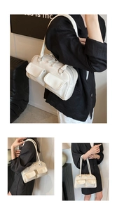 Detail of white bowling bag with cracked leather texture and two front flap pockets