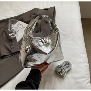 Detailed shot of metallic silver hobo bag with pleated texture and metal ball charm