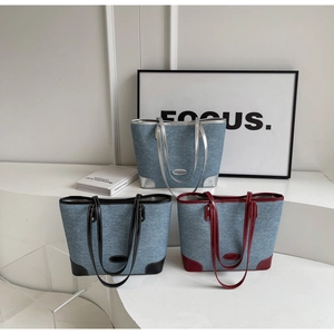 Detailed trio of denim tote bags in silver, black and burgundy on geometric steps