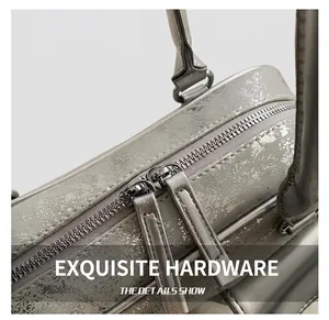 Detail of silver metallic cracked leather shoulder bag with dual zipper hardware
