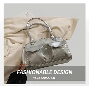 Detail of silver distressed oil wax leather shoulder bag with two symmetric front pockets