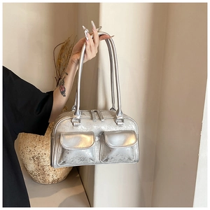 Detail of silver oil wax leather bowling bag with vintage cracked texture and dual pockets