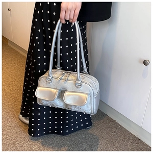 Detail of silver metallic oil wax leather Boston bag with two front flap pockets