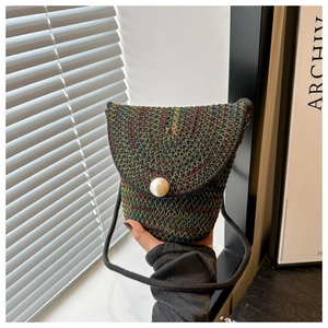Dettaglio della mini borsa nera tessuta a mano con ricami colorati e chiusura a perla