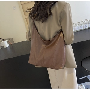 Detailed view of brown vintage PU leather hobo bag showing texture and large capacity size