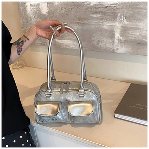 Detail of silver metallic oil wax leather boston bag with dual front flap pockets