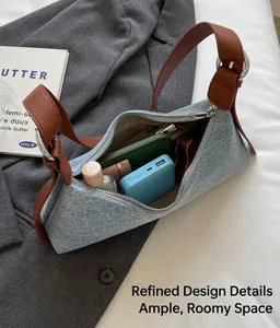 Top view of denim baguette bag interior showing space for power bank and accessories