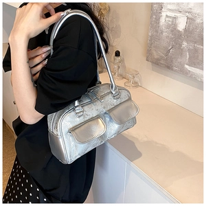 Close-up of silver cracked oil wax leather shoulder bag with double front flap pockets