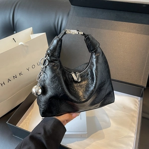 Glossy black wrinkled leather half-moon handbag with silver metallic sphere charm
