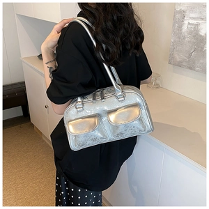 Detail of silver metallic Boston bag with dual front pockets and vintage oily texture