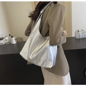 Silver metallic pleated tote bag shown on model for daily commuting style