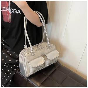 Detail of silver oil wax leather bowling bag with dual front pockets and shoulder straps