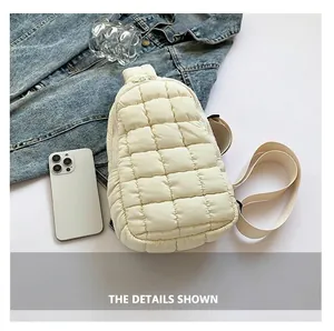 Close-up of white quilted nylon chest bag with soft padded texture and crossbody strap