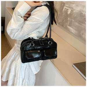 Close-up of black crinkled leather Boston bag with silver hardware and double front pockets