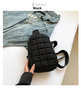 Close-up of black quilted nylon chest bag with waterproof texture and sleek zipper