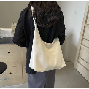 White large capacity shoulder tote bag with soft texture shown on a model