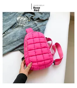 Detailed view of the rose red quilted nylon sling bag with a textured diamond pattern