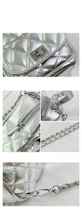 Detail of silver quilted texture with metallic chain strap and turn-lock closure