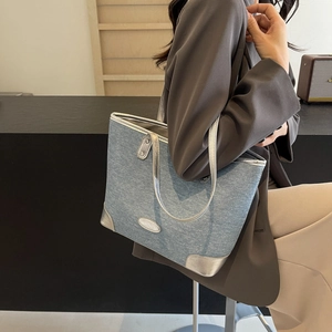 Minimalist light blue denim tote bag with silver metallic accents for daily commuting