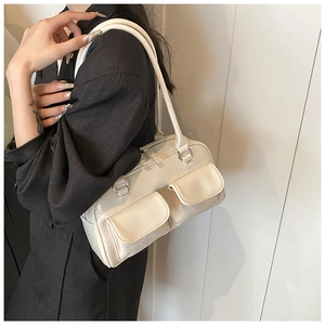 Close-up of cream Boston bag with lychee texture and decorative front pockets