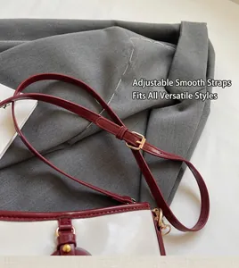 Close-up of contrast color bucket bag with adjustable strap and golden metal buckle