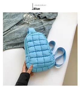 Close-up of blue quilted nylon crossbody bag featuring textured square stitching detail