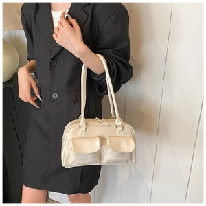 Detail of off-white glossy underarm bag with double front pockets on a model