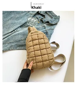 Close-up of khaki quilted nylon crossbody bag with square stitching and fabric strap